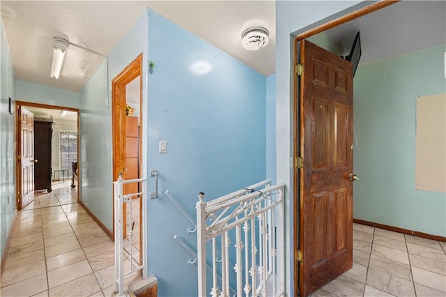 hall featuring light tile patterned flooring