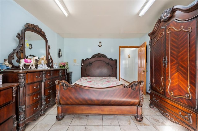 bedroom with light tile patterned floors