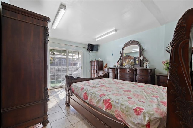 bedroom with light tile patterned floors and access to outside