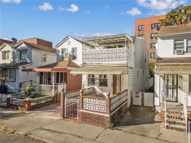 view of front of home with a gate and cooling unit