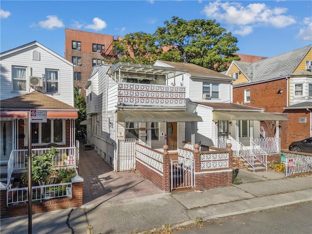 view of front of property with fence and a porch