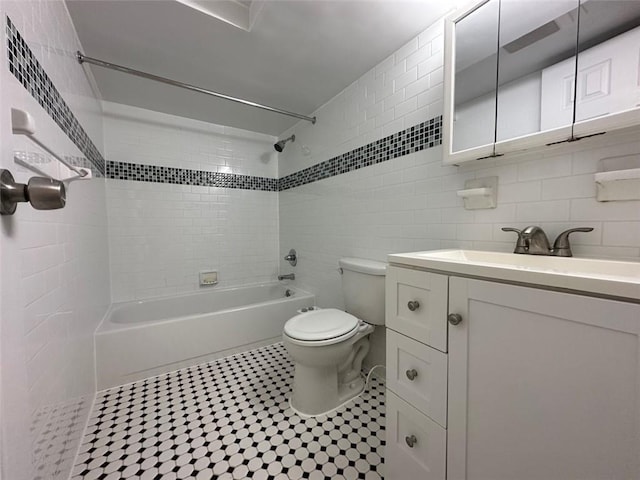 full bathroom featuring vanity, backsplash, tile patterned flooring, toilet, and tile walls