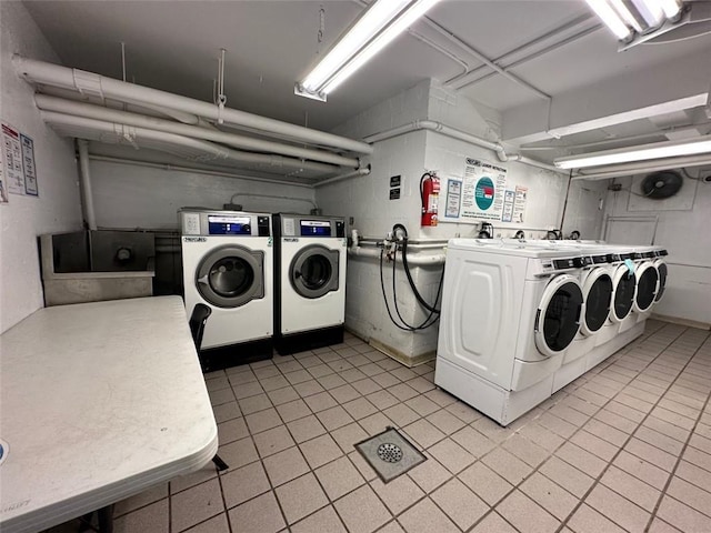 clothes washing area with washer and clothes dryer