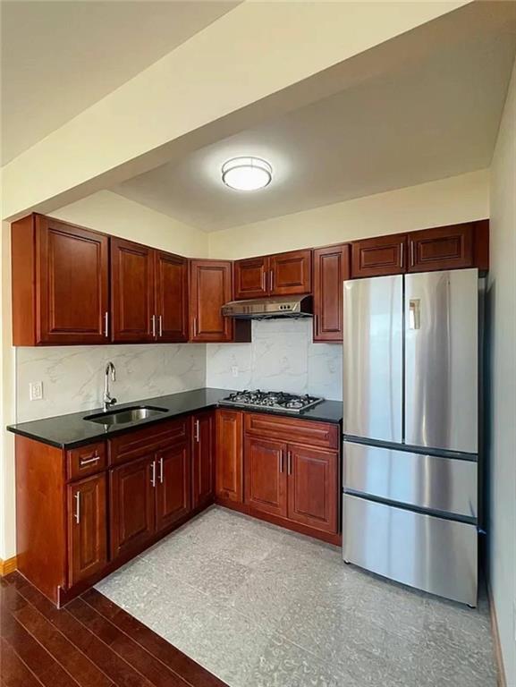 kitchen with decorative backsplash, appliances with stainless steel finishes, and sink