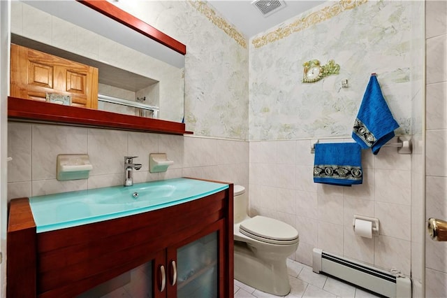 bathroom with tile patterned flooring, visible vents, toilet, tile walls, and a baseboard radiator