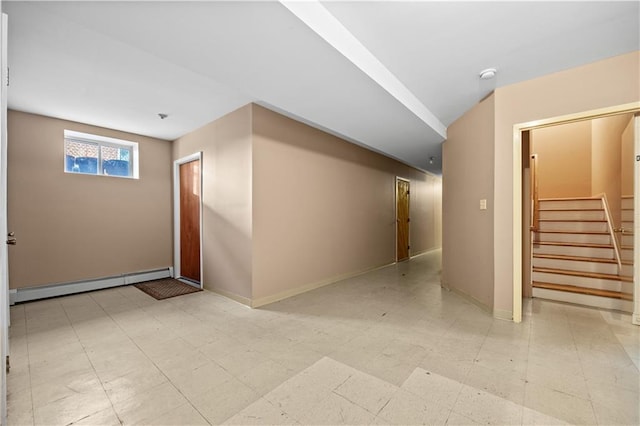 corridor with baseboards, baseboard heating, light floors, and stairs