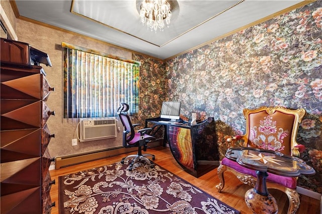 home office featuring a wall unit AC, wood finished floors, a baseboard radiator, crown molding, and a notable chandelier