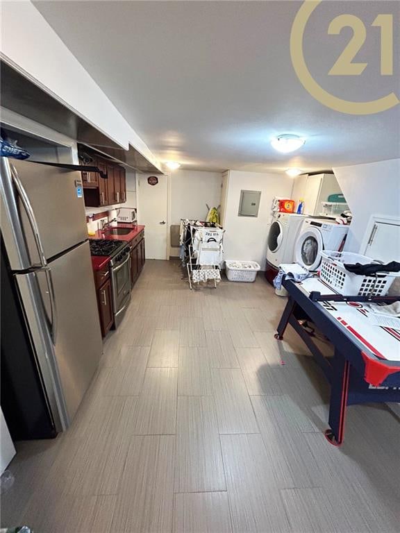 washroom featuring washing machine and clothes dryer and electric panel