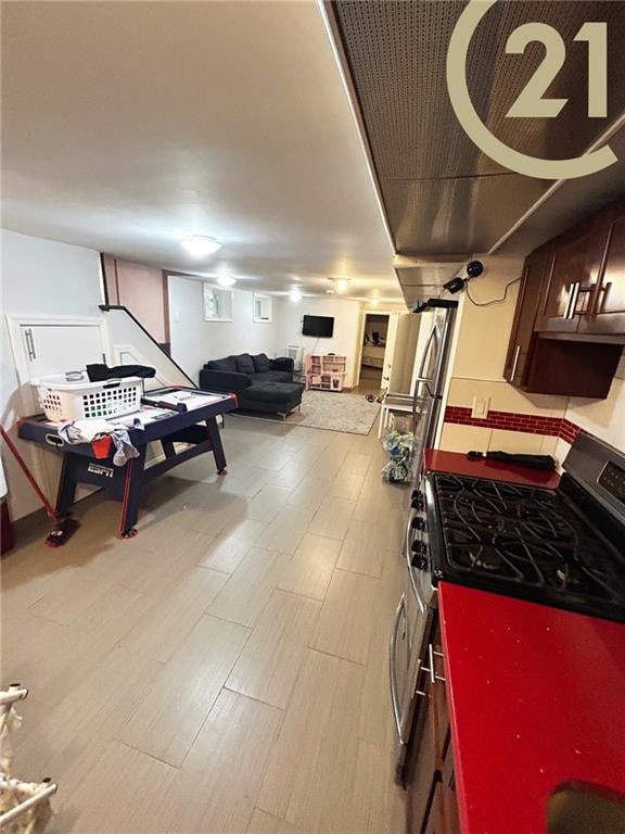 interior space with dark brown cabinets and range with gas cooktop