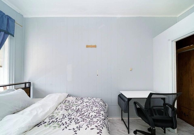 bedroom featuring crown molding and wooden walls