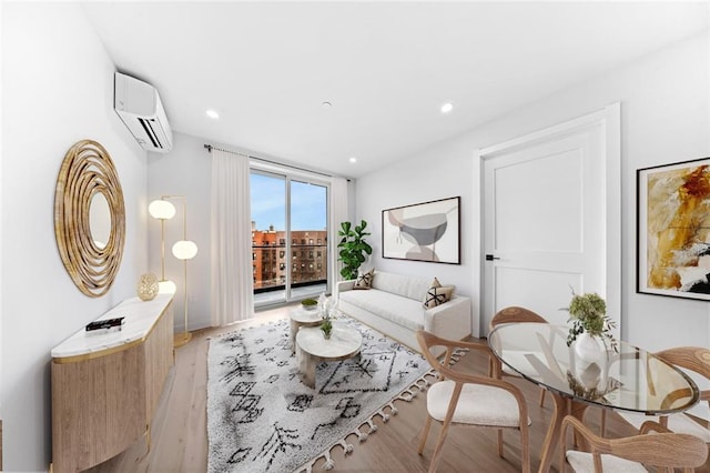 living room featuring a wall mounted air conditioner, light wood-style flooring, and recessed lighting