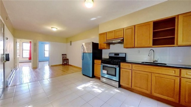 kitchen featuring sink, light tile patterned floors, a baseboard radiator, and stainless steel appliances