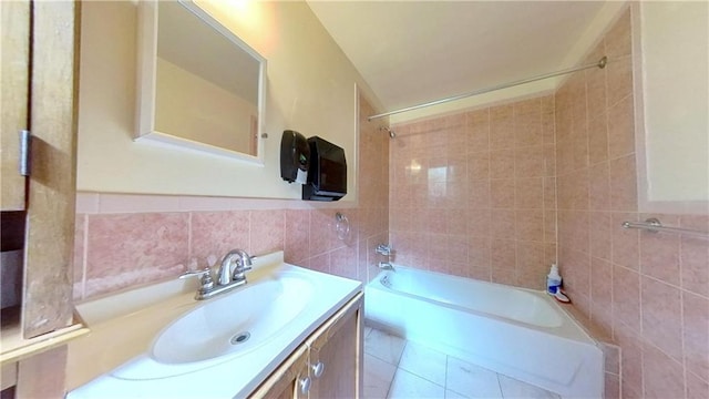 bathroom with tile patterned floors, tile walls, shower / washtub combination, and vanity