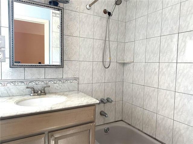 full bath featuring  shower combination, vanity, and decorative backsplash