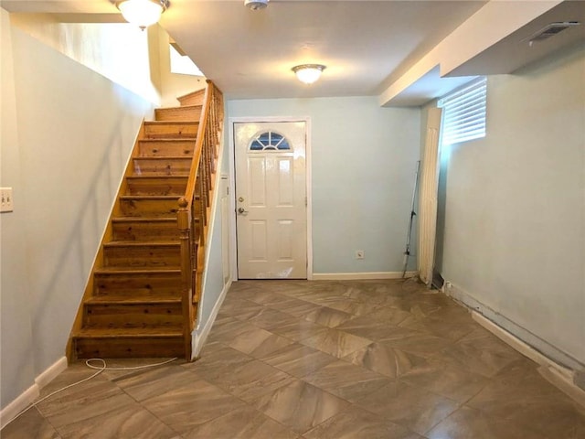 foyer featuring visible vents, baseboards, and stairs