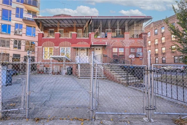 exterior space featuring a gate, brick siding, and fence