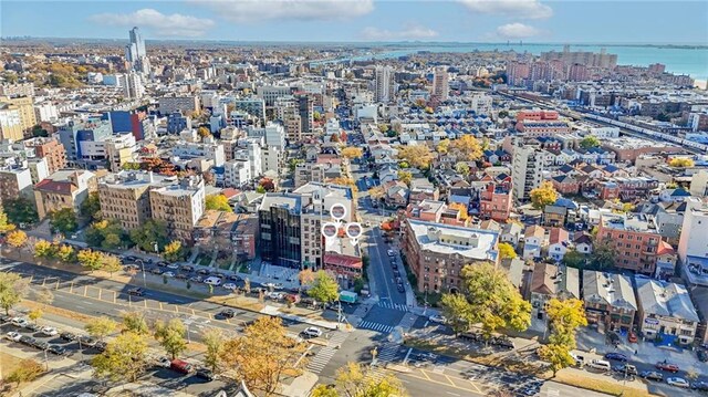 bird's eye view featuring a water view and a city view