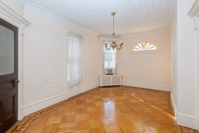 unfurnished dining area featuring ornamental molding, parquet flooring, radiator, and a notable chandelier