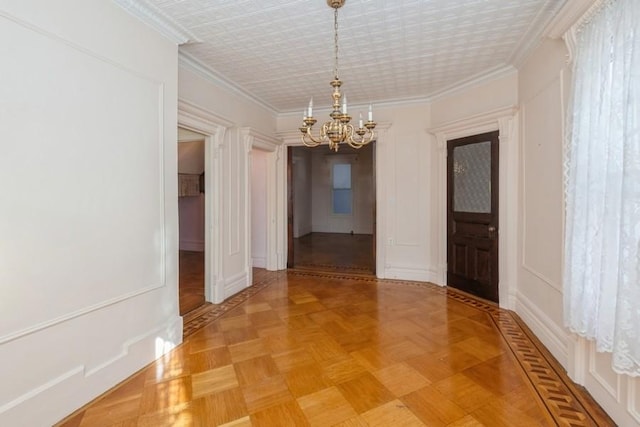 interior space featuring parquet floors, crown molding, and a chandelier