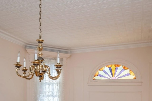 room details featuring ornamental molding and a notable chandelier