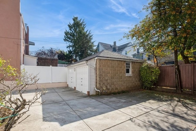 view of home's exterior with a garage and an outdoor structure