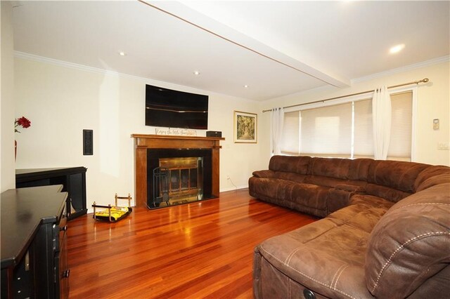 living room with ornamental molding and hardwood / wood-style floors