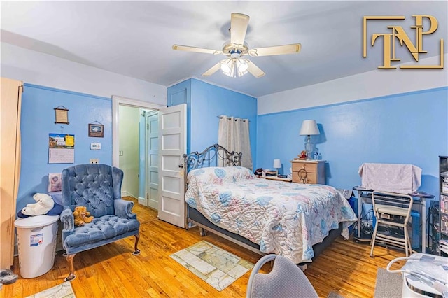 bedroom featuring a ceiling fan and wood finished floors