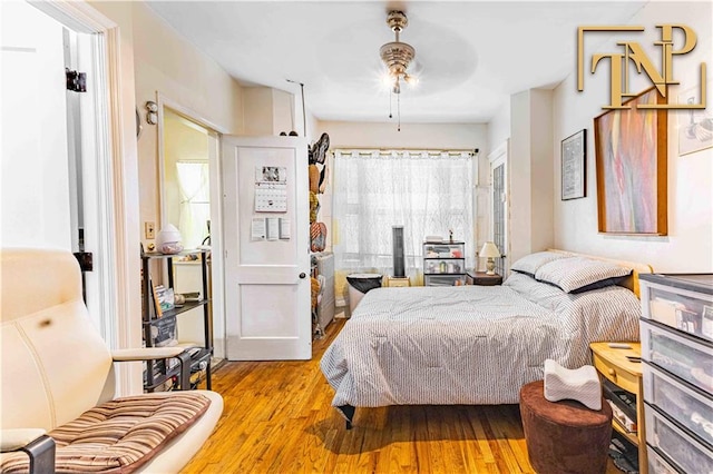 bedroom featuring ceiling fan and light hardwood / wood-style floors