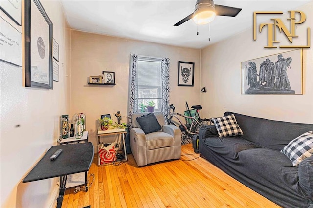 living room featuring ceiling fan and hardwood / wood-style floors