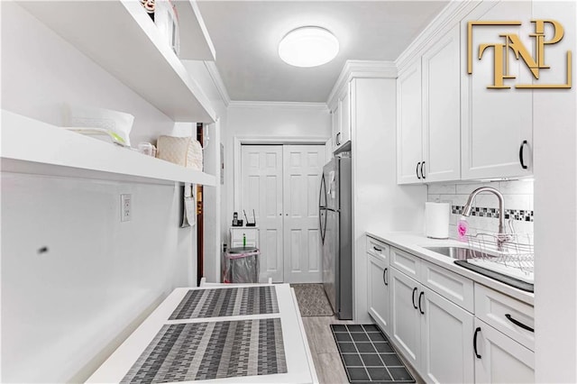 interior space with a sink and ornamental molding