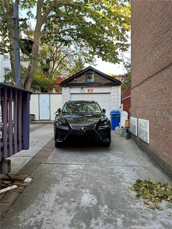 detached garage featuring concrete driveway