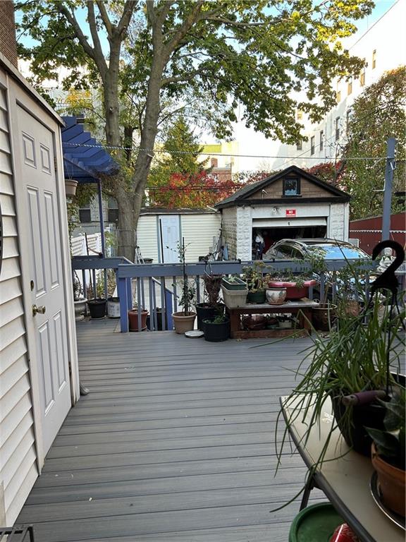 wooden terrace featuring an outdoor structure