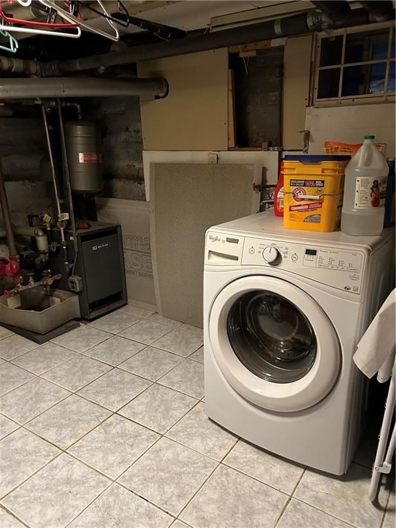 clothes washing area with light tile patterned floors and washer / clothes dryer