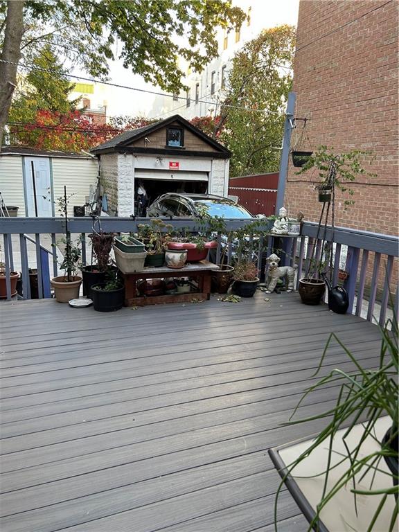 wooden terrace featuring a shed