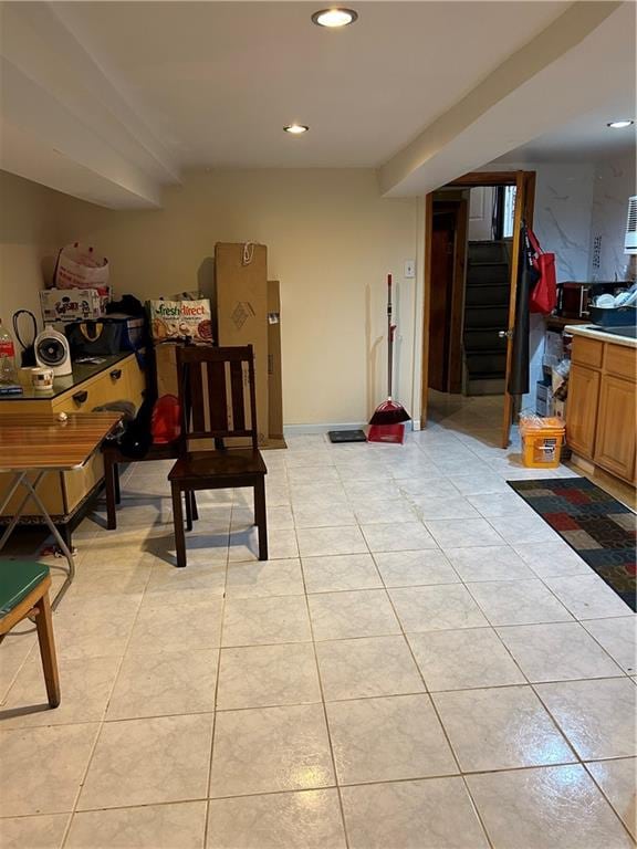 basement with light tile patterned floors, recessed lighting, and stairs