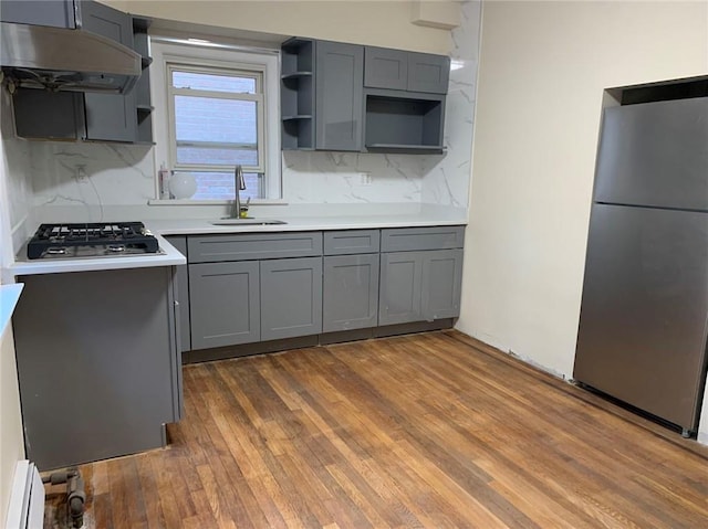 kitchen featuring open shelves, appliances with stainless steel finishes, under cabinet range hood, and gray cabinets