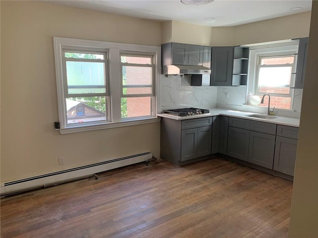 kitchen with gray cabinets, a baseboard heating unit, and a sink