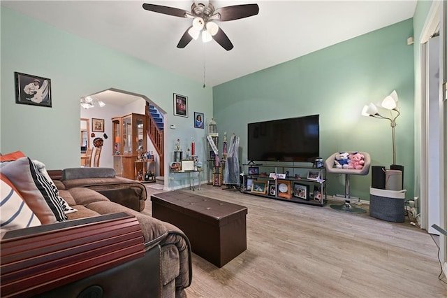 living room with light hardwood / wood-style flooring and ceiling fan