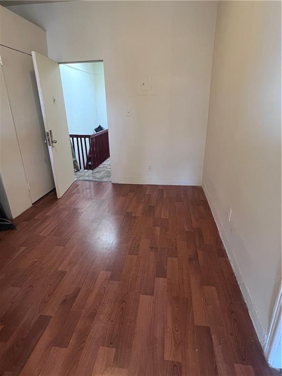 empty room featuring dark wood-type flooring