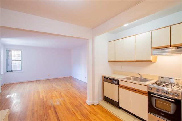 15 Oliver St Unit 4C, Brooklyn, NY 11209 - kitchen featuring stainless steel gas range oven, dishwasher, range hood, a sink, and light wood-style flooring
