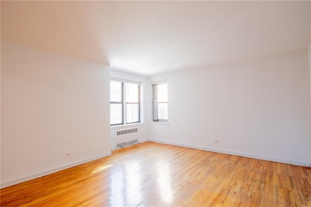 15 Oliver St Unit 4C, Brooklyn, NY 11209 - unfurnished room with radiator, light wood-style flooring, and baseboards