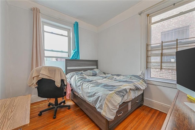 bedroom featuring wood-type flooring and baseboards