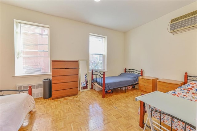 bedroom featuring a wall mounted air conditioner and radiator heating unit