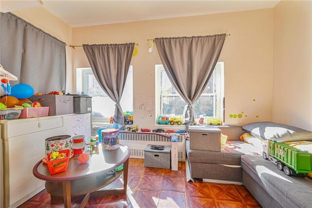 playroom featuring parquet flooring and radiator