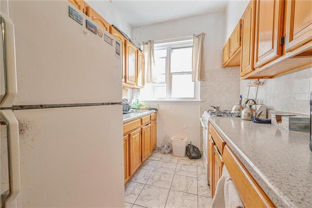 kitchen featuring white appliances, light countertops, marble finish floor, and backsplash