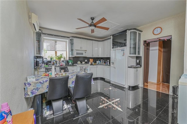 kitchen with a wall mounted air conditioner, glass insert cabinets, white appliances, and granite finish floor