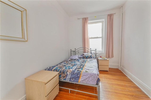 bedroom featuring baseboards and light wood-type flooring