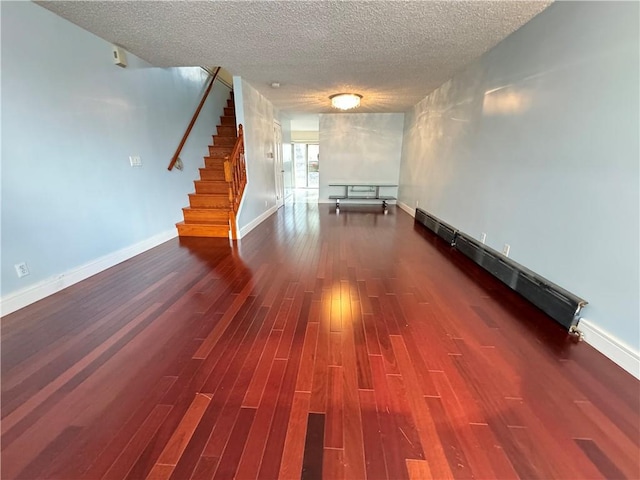 interior space featuring a textured ceiling and dark hardwood / wood-style flooring