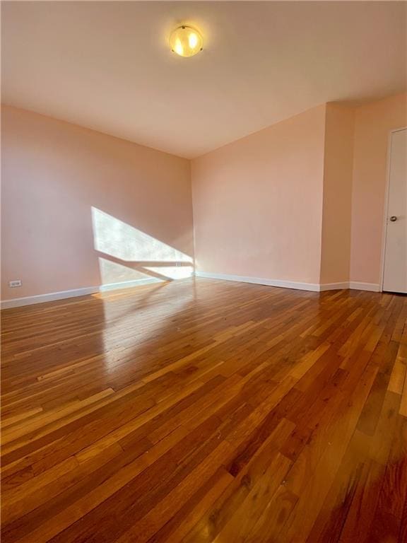 unfurnished room with hardwood / wood-style flooring