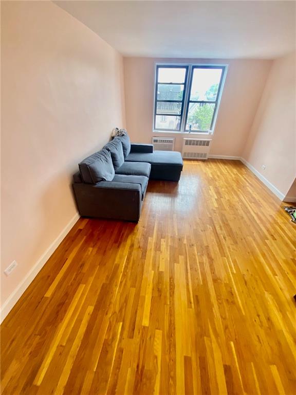 living room featuring wood-type flooring and radiator